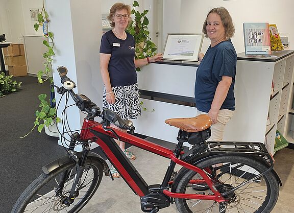 Amelie Döres vom ADFC Rheinland-Pfalz übergibt die Auszeichnung "Fahrradfreundlicher Arbeitgeber" an die Oberbürgermeisterin der Stadt Ingelheim, Eveline Breyer